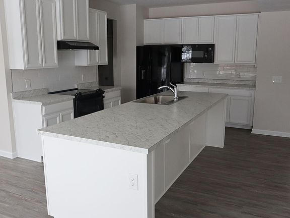 Kitchen with modern cabinets and backsplash. Nest termostat installed Appliances GE: refrigerator, slidein stove/oven, exhaust hood, microwave, dishwasher