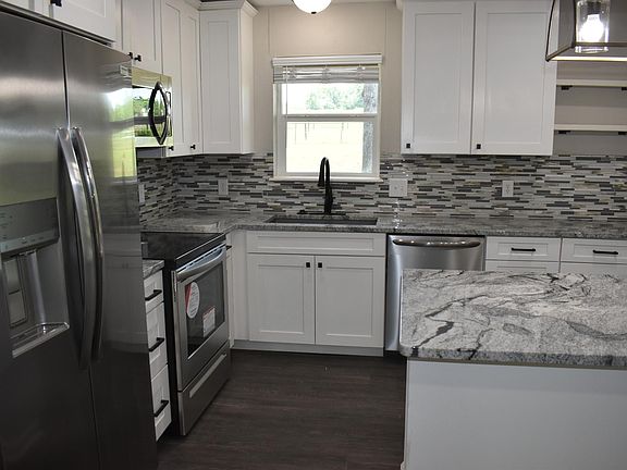 Fully updated Kitchen with island, granite countertops, New Cabinets and Backsplash. The home has New Stainless Steel Appliances and New Light Fixtures.