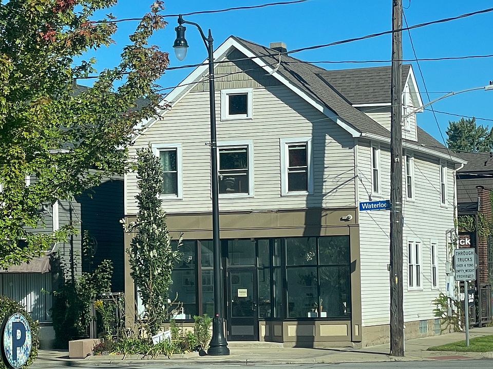 Apartment windows above the storefront (Mortar Gallery). Exterior of house.
