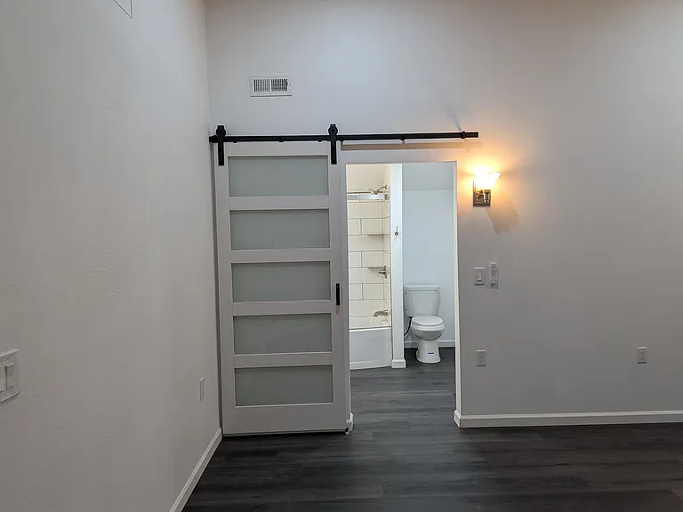 No wasted space with modern barn bathroom door to master bath.