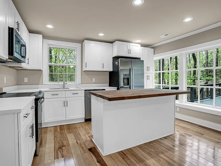 Stainless steel appliances. Maple Butcher block counter top for Island and quartz countertops.
