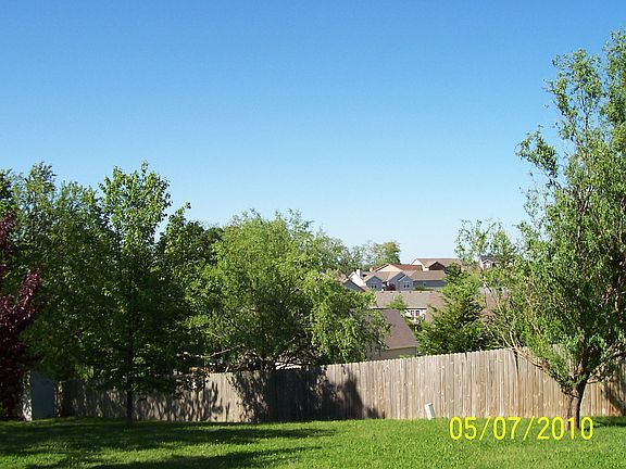 large fenced yard with shed