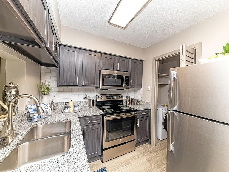 Kitchen with stainless appliances, granite counters, and modern cabinetry