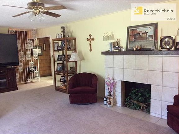 New carpet and a beautiful fireplace accent the living room.