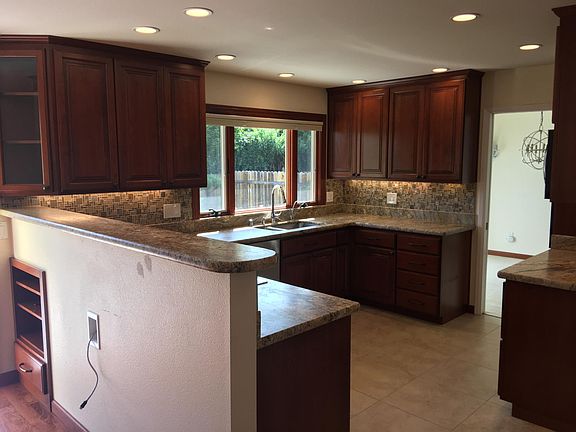 Kitchen and den custom cherry cabinetry with pull out drawer