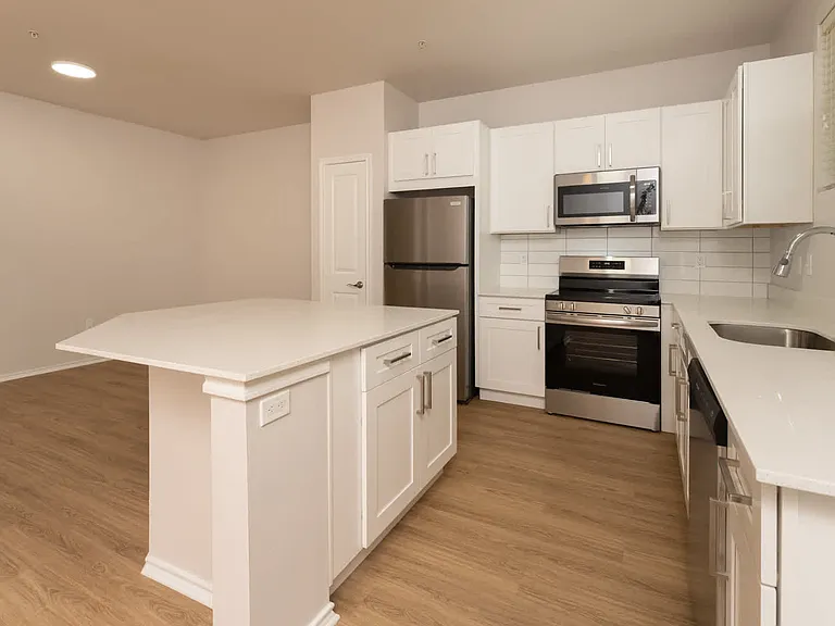 Kitchen with island and hard surface flooring