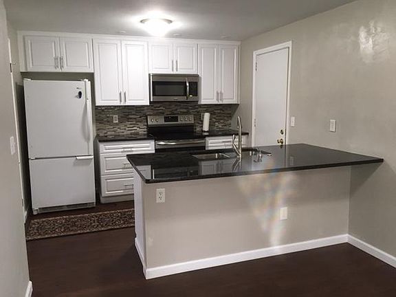 Fully remodeled kitchen. New cabinets, granite counters, new electric range, microwave and DW. Door exits to one car garage.