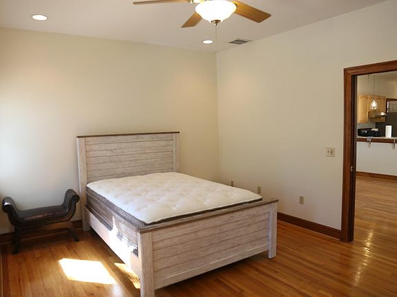 Bedroom 1 with ceiling fan and central AC