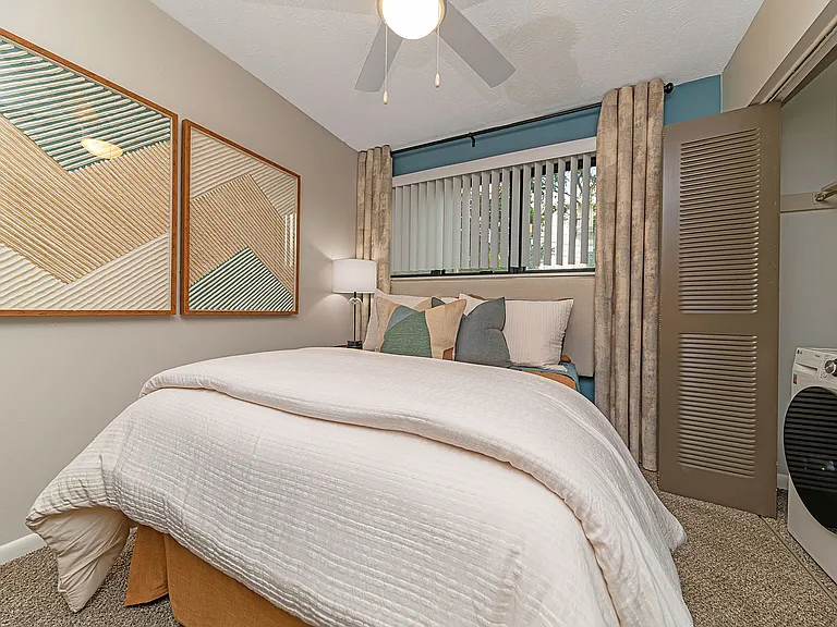Cozy bedroom with carpet and ceiling fan