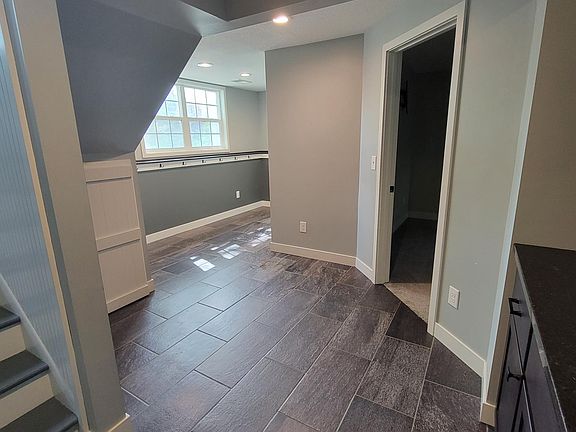 Lower level has a large mud room with powder bath, wet bar with mini fridge, family room, Primary bedroom with private bath and access to a heated shop between the garage and home.