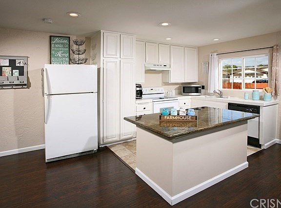 The chef in the family is going to truly appreciate the bright and spacious kitchens recessed lighting, up-to-date paneled white cabinets that reach the ceiling, tile counter-tops with back-splash, newer dual basin sink and faucet, self-cleaning electric 