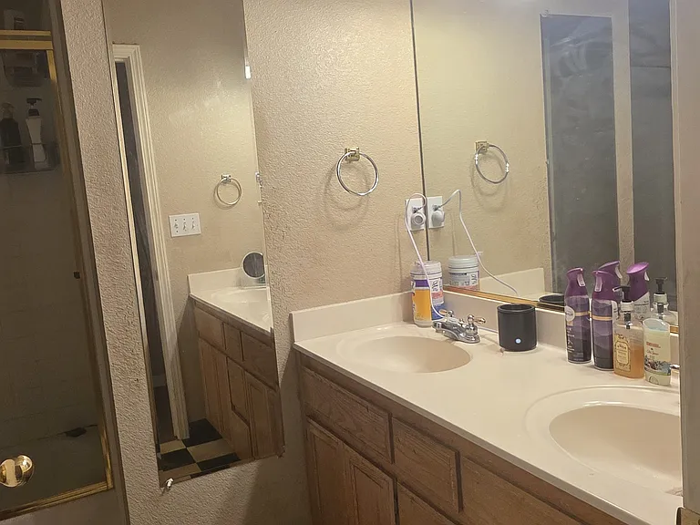 Upstairs shared bathroom with two sinks and storage area for two. One other roommate shares this full bathroom. There is also a 3Rd bathroom downstairs near the door entry area.