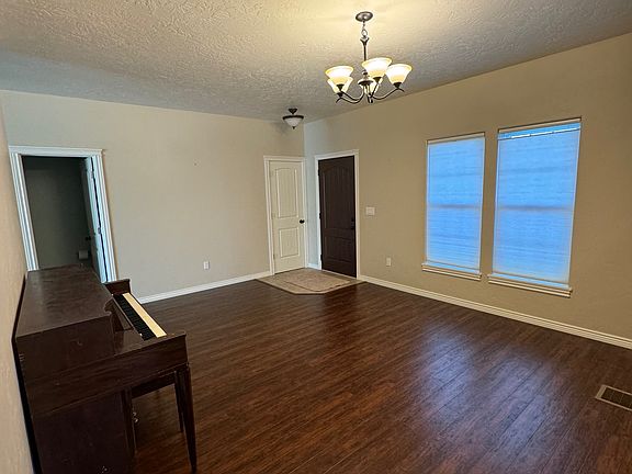 Front Entry, Closet, Guest 1/2 Bathroom. Piano still in home.