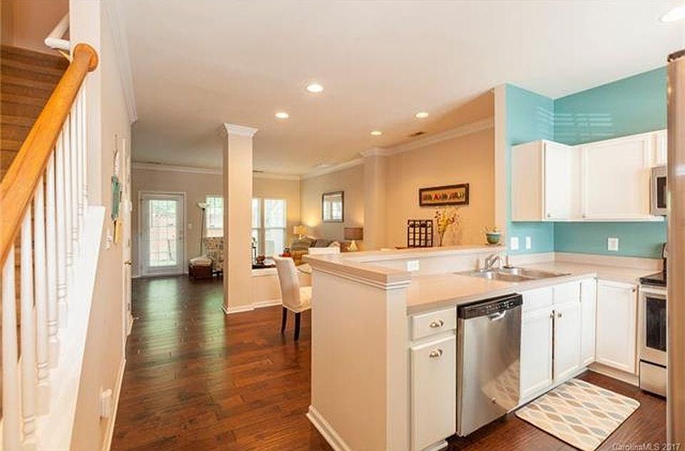 View from front entrance of kitchen, dining, and living room