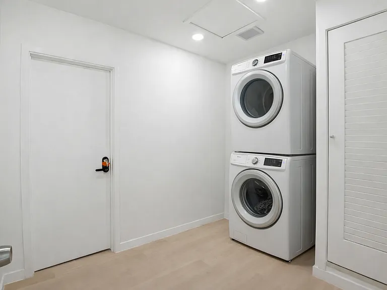 Shared laundry _ washer and dryer, iron and ironing board.