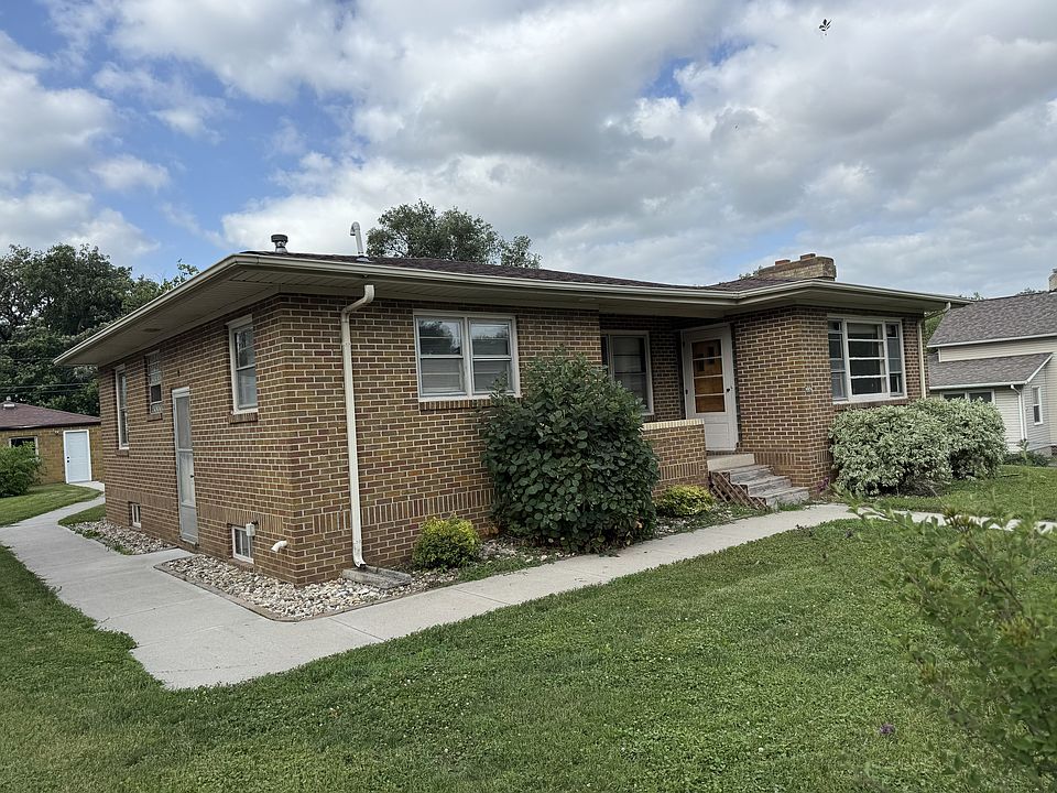 Front of house. Side door and sidewalk out to two car detached garage/workshop