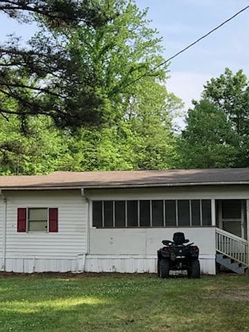 Front porch of house & driveway fix_s three or four cars (that is driveable