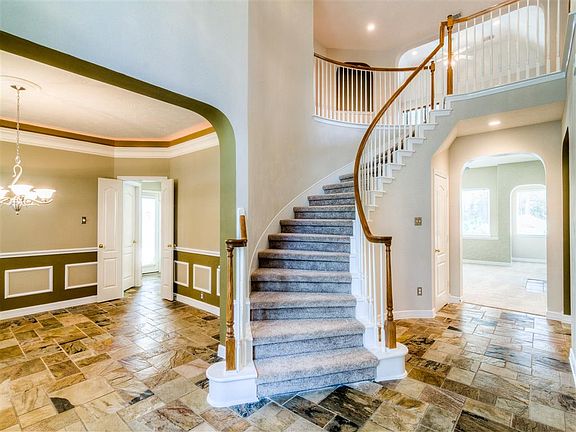 Soaring ceilings and a spiral staircase make a grand first impression.