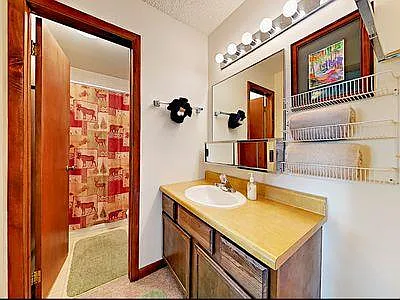 En suite bathroom to bedroom with queen bed.