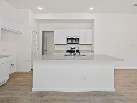 Kitchen in the Elm home plan by Trophy Signature Homes - REPRESENTATIVE PHOTO