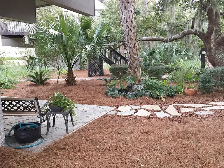 Patio and garden yard make a lush setting.
