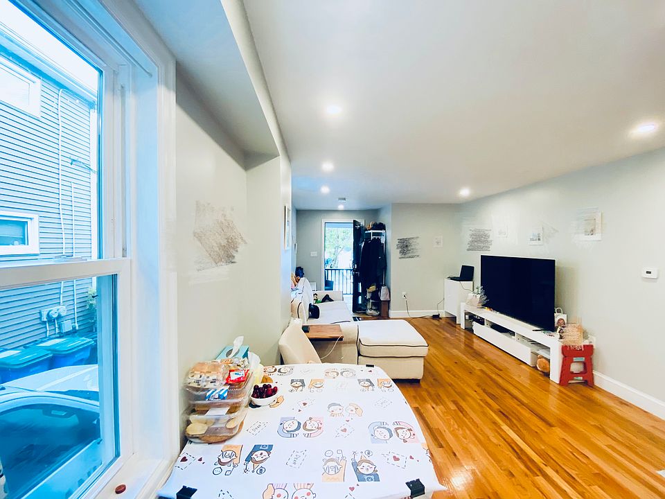 Living room with hardwood floor and two windows to get great daylight.