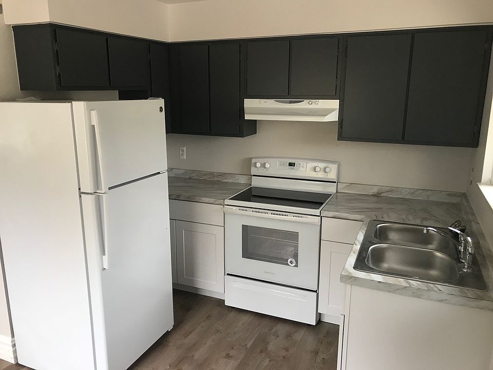 Renovated kitchen includes: new fridge, stove, lower cabinets, countertops, sink and flooring.