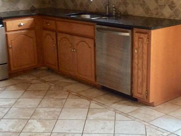 Hardwood Oak cabinets are complemented by granite countertop