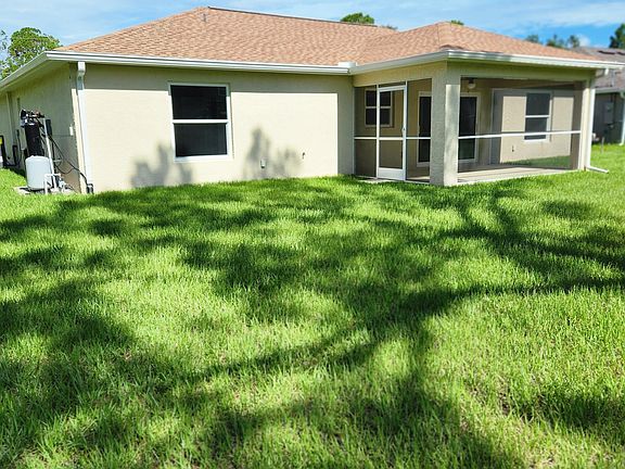 Back yard, lanaii, and water softener system.