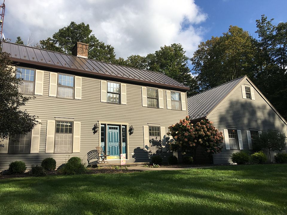 wood siding. Metal roof