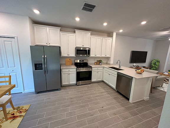 Enjoy the convenience of modern living in this kitchen, complete with brand new appliances. While you can certainly cook up a storm, it's also the perfect space to enjoy takeout with ease. Order in and savor your meal at the stylish dining area.