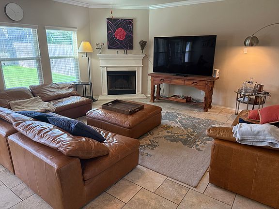 main living room downstairs with italian leather sofas and 75" smart tv