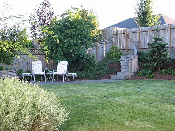 tasefully landscaped fenced backyard