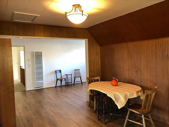 Eating area with living room in back.