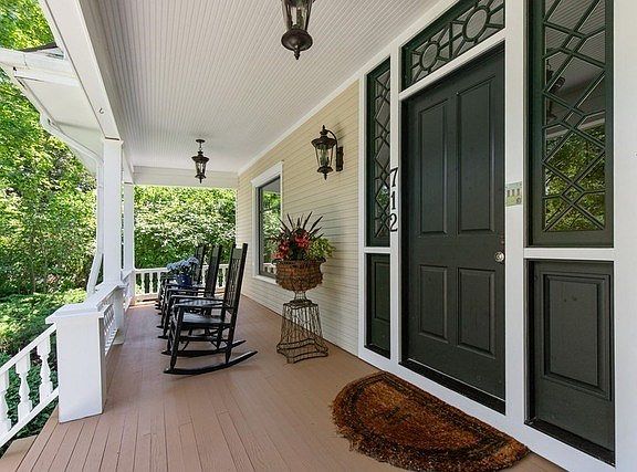Relax and enjoy the yard and neighborhood from this front porch.