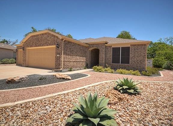 A wide cul-de-sac lot offers abundant privacy at this choice Sun City Texas Copper Ridge hugging the winding banks of Cowan Creek.