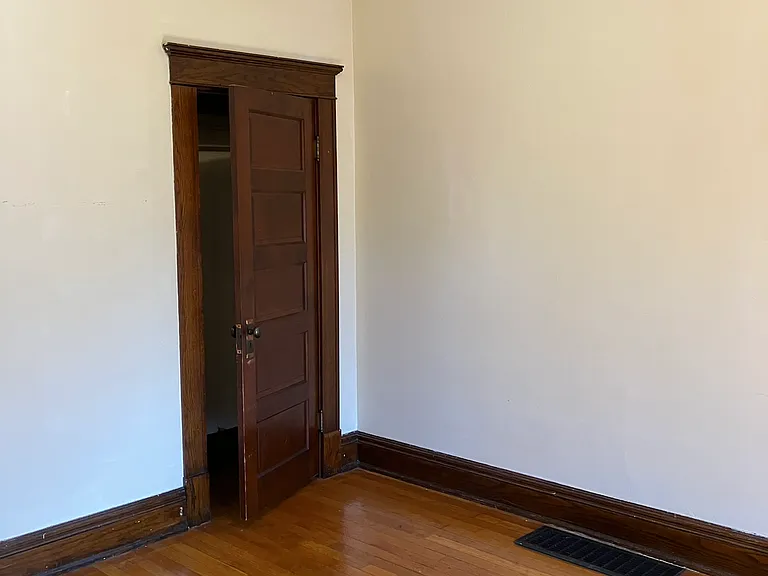 Bedroom off of living room, closet door and facing right wall