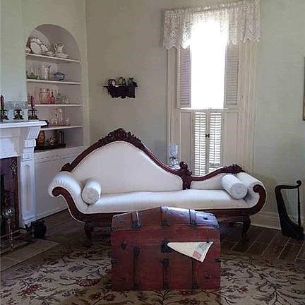 Parlor room with crown molding; shutters for window covering; built in decorative niches and cupboards to hold your antique treasures