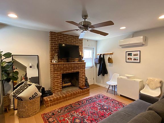 Main Living Room. With exposed brick fireplace. Separate energy efficient AC/Heating unit. Premium tile flooring.