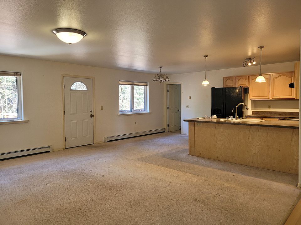 Open living room and kitchen with door to deck