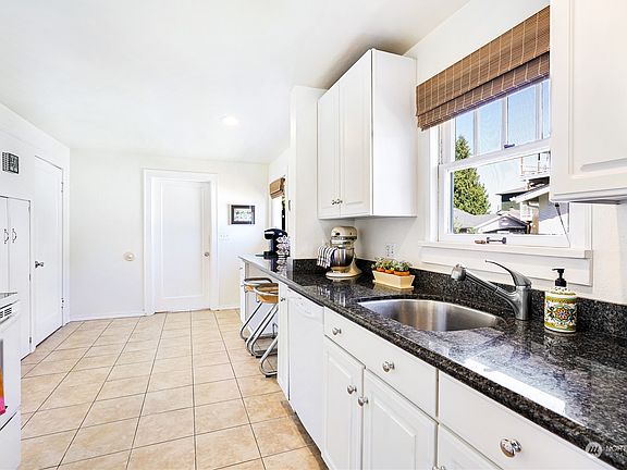 Galley kitchen with granite countertops>
