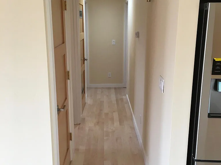 Hallway to bedrooms, laundry, second bathroom
