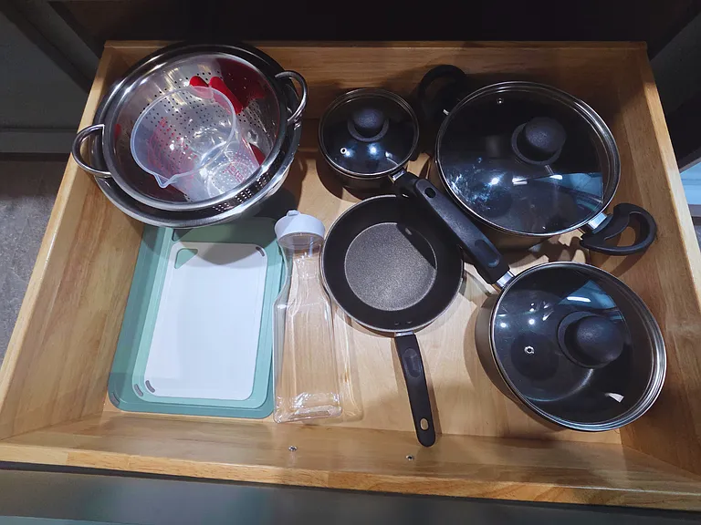 Enjoy home-style cooking with pots, pans, and a practical cutting board.