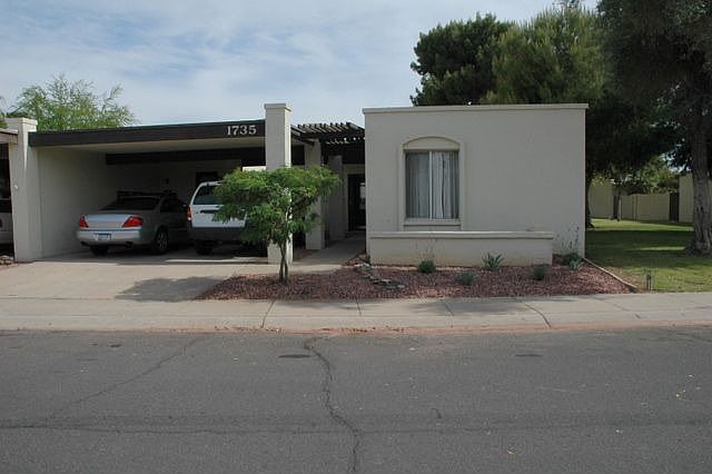 Front yard with desert landscape and adjacent greenbelt