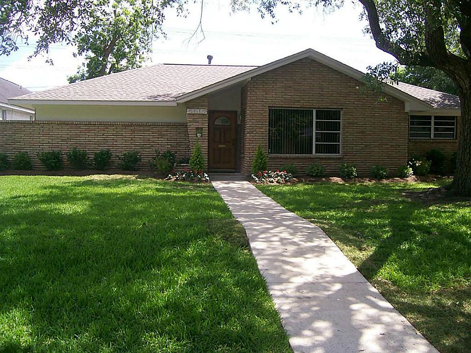 Fresh landscaping surrounds home.