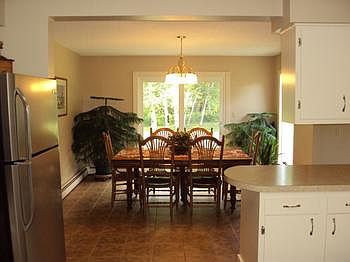 The dining area is located off the living room and has a sliding glass door to the backyard. Features ceramic tile flooring.