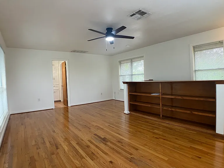 Upstairs bedroom, bookcase and large windows