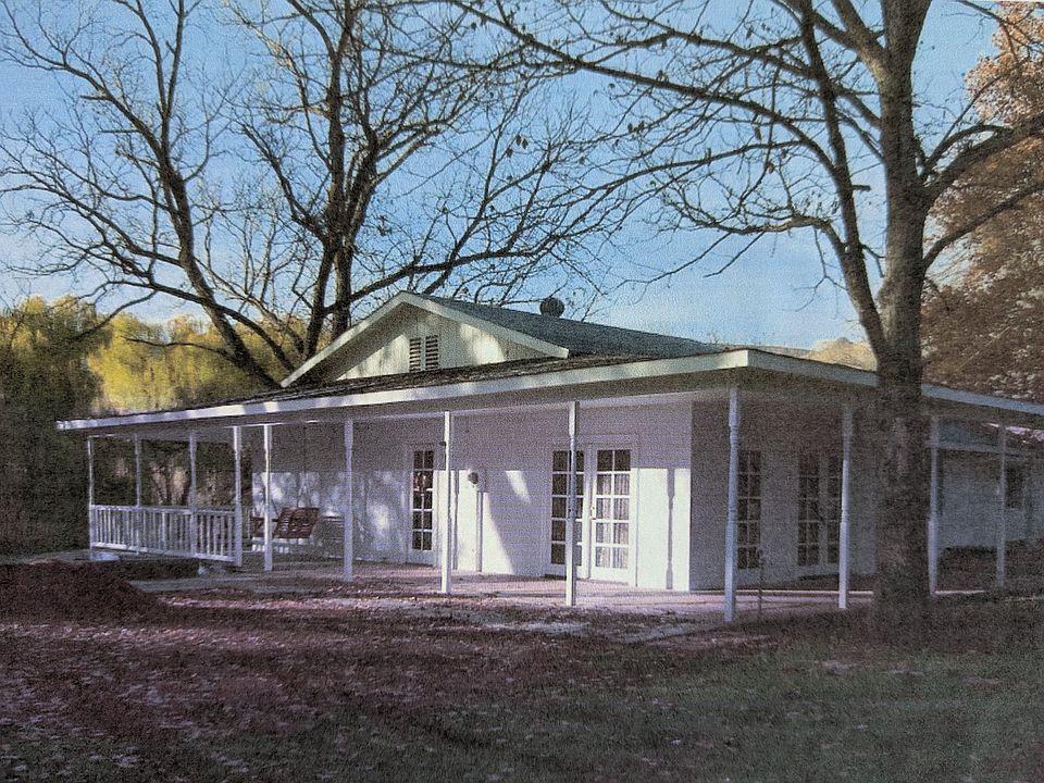 Outside view of home with perimeter porch and swing