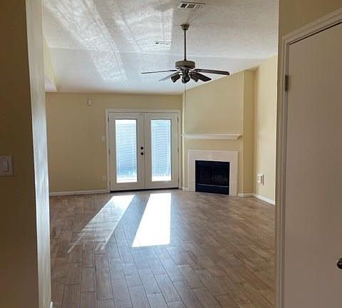 Family room with gas fireplace and french doors to backyard deck.