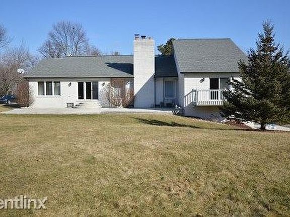 Back view with large stamped concrete patio